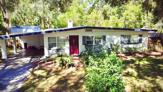 a backyard of a house with yard and outdoor seating