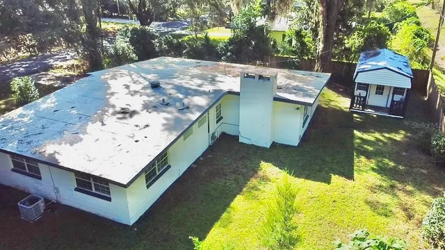 a view of a lounge chair in the backyard of a house
