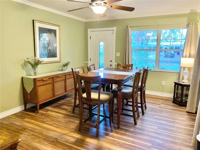 a view of a dining room with furniture and wooden floor