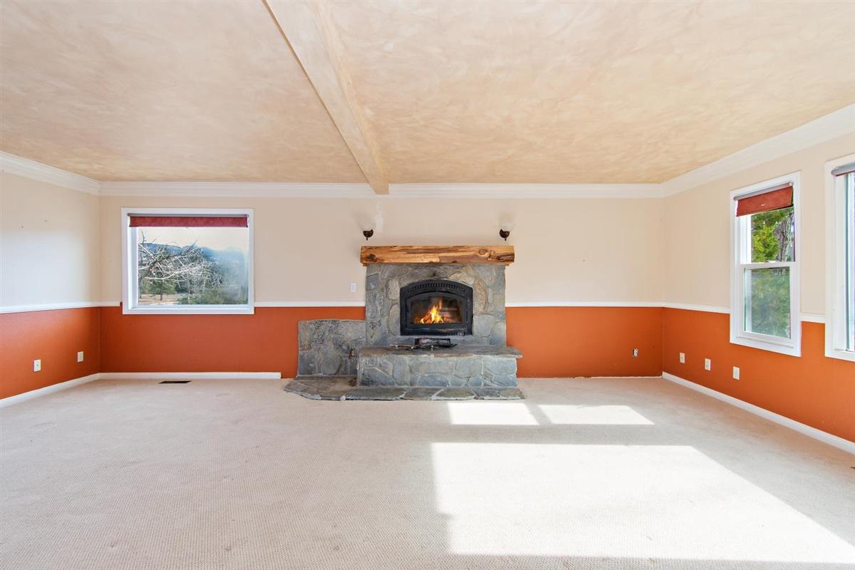 59911 Hop Patch Spring Road Mountain Center, CA 92561 - Photo 11 of 42 an empty room with windows and fireplace