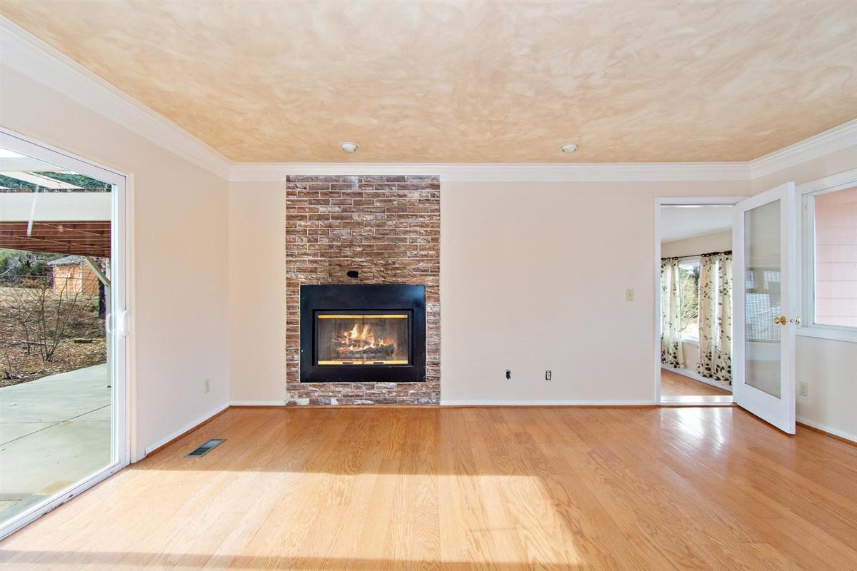 59911 Hop Patch Spring Road Mountain Center, CA 92561 - Photo 8 of 42 a view of an empty room with wooden floor and a fireplace