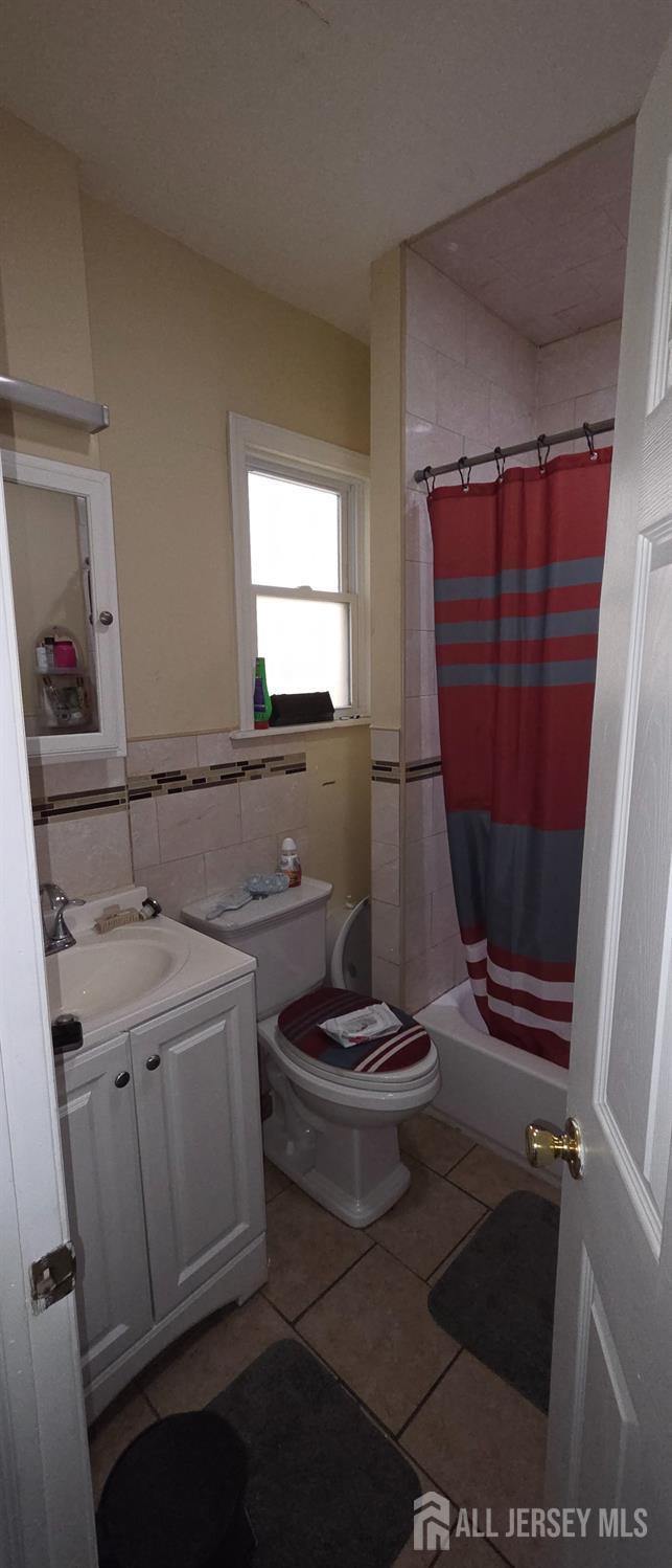136 Smith Street Elizabeth, NJ 07201 - Photo 12 of 36 a bathroom with a sink a toilet and a mirror