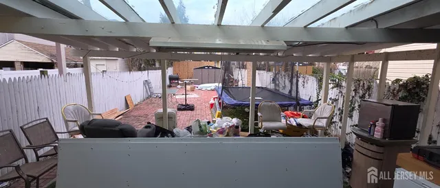 a room with lots of furniture and a potted plant