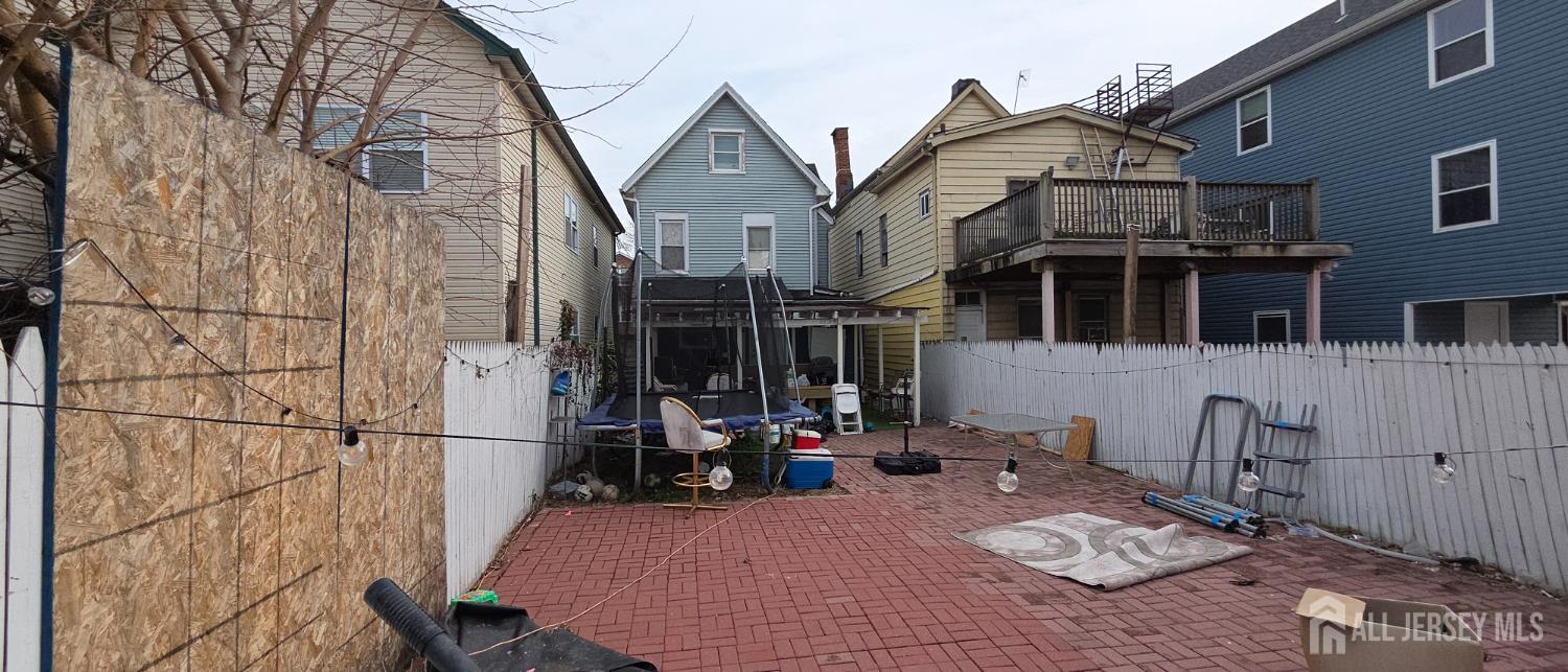 136 Smith Street Elizabeth, NJ 07201 - Photo 19 of 36 a view of a wooden house with a bench in it