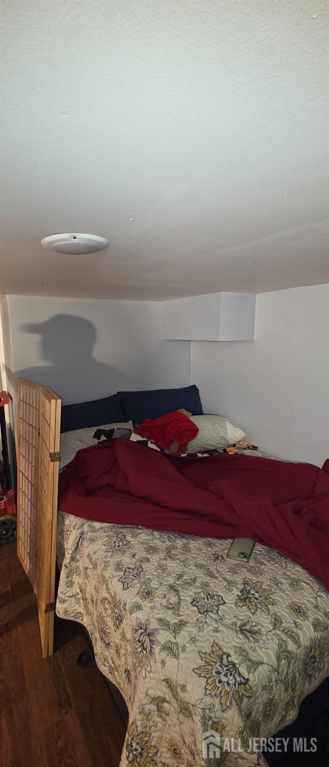 136 Smith Street Elizabeth, NJ 07201 - Photo 26 of 36 a bed sitting in a bedroom next to a window