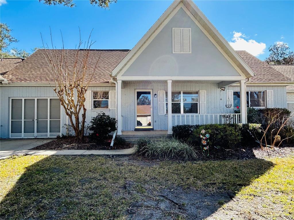 a view of a house with backyard and porch