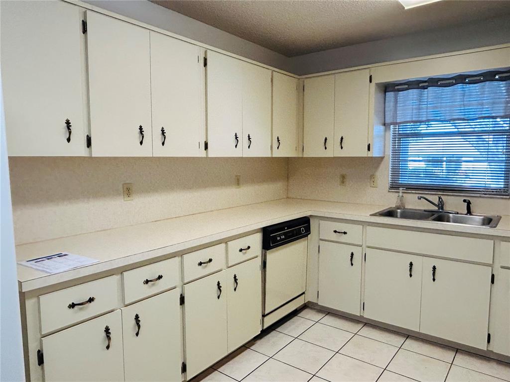 8530 Southwest 90th Street, Unit B Ocala, FL 34481 - Photo 12 of 45 a kitchen with granite countertop white cabinets and white appliances