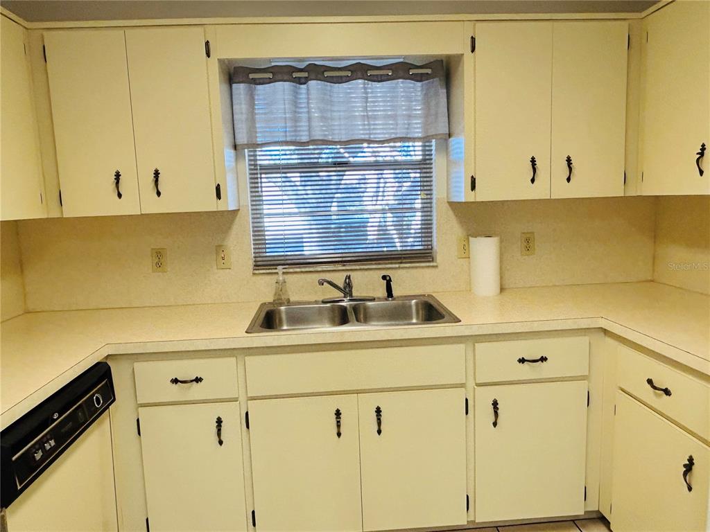 8530 Southwest 90th Street, Unit B Ocala, FL 34481 - Photo 13 of 45 a kitchen with a sink and cabinets