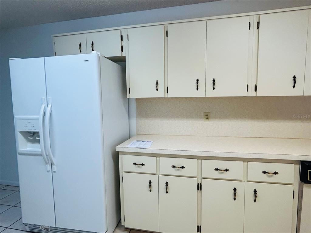 8530 Southwest 90th Street, Unit B Ocala, FL 34481 - Photo 16 of 45 a view of a kitchen with cabinets and a refrigerator