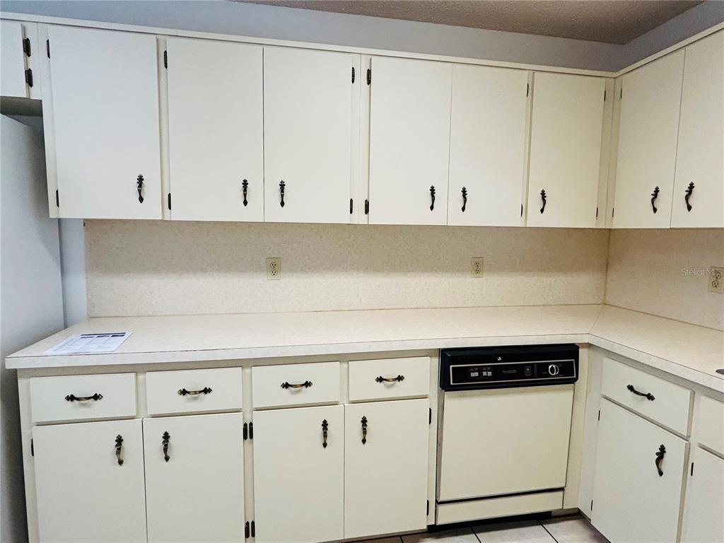 8530 Southwest 90th Street, Unit B Ocala, FL 34481 - Photo 17 of 45 a kitchen with white cabinets and white appliances