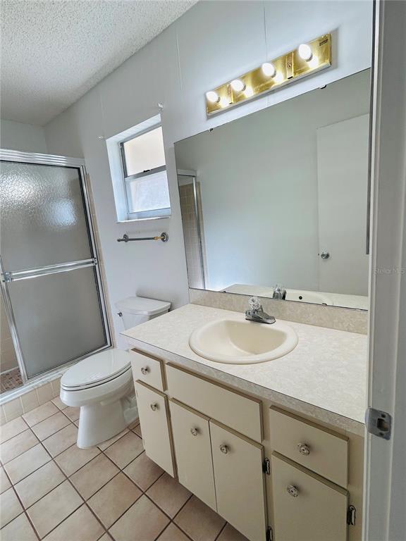 8530 Southwest 90th Street, Unit B Ocala, FL 34481 - Photo 20 of 45 a bathroom with a sink a toilet and mirror