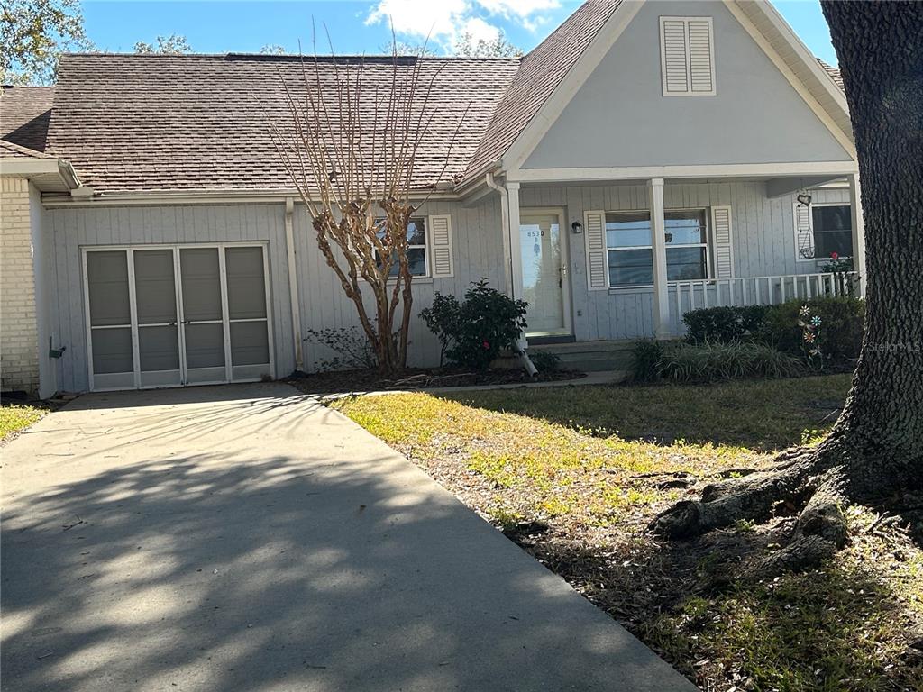 8530 Southwest 90th Street, Unit B Ocala, FL 34481 - Photo 2 of 45 a front view of a house with a yard