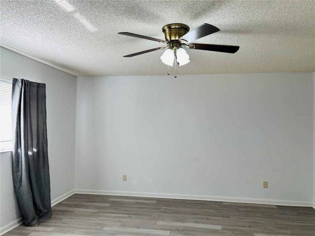 8530 Southwest 90th Street, Unit B Ocala, FL 34481 - Photo 26 of 45 wooden floor in an empty room