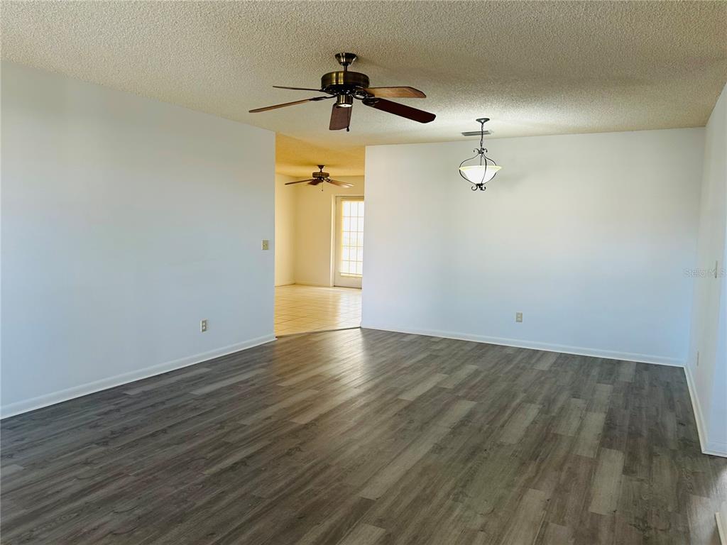 8530 Southwest 90th Street, Unit B Ocala, FL 34481 - Photo 34 of 45 an empty room with wooden floor and fan