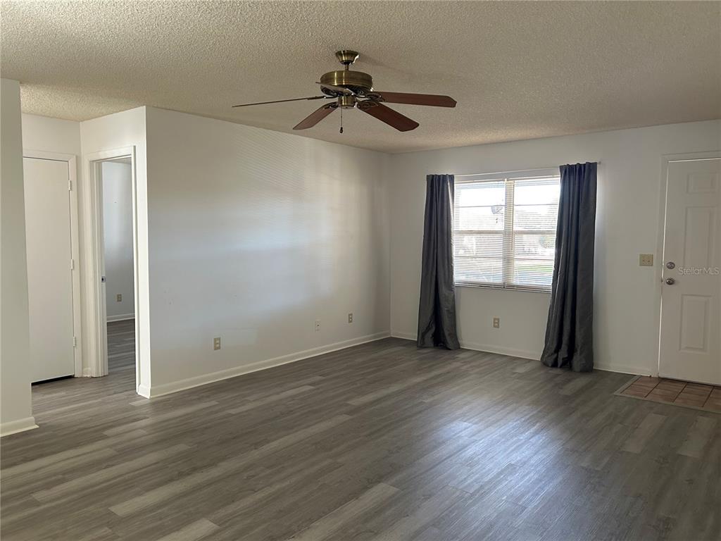 8530 Southwest 90th Street, Unit B Ocala, FL 34481 - Photo 36 of 45 wooden floor in an empty room with a window