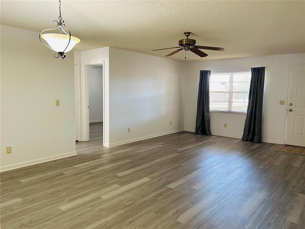 8530 Southwest 90th Street, Unit B Ocala, FL 34481 - Photo 37 of 45 wooden floor in an empty room with a window