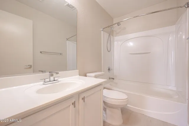 a bathroom with a sink a toilet and a large mirror