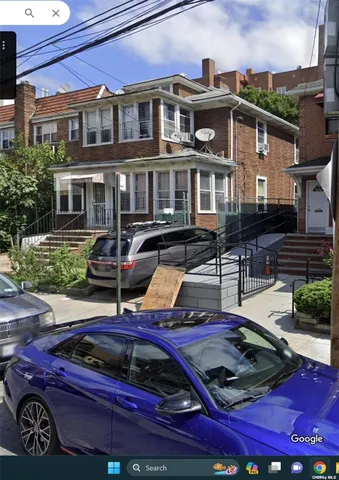 a front view of a house with a garden and sitting area