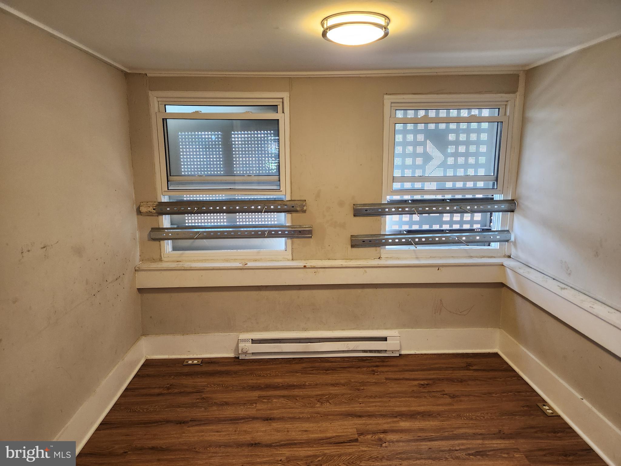 113 Eastern Boulevard Essex, MD 21221 - Photo 3 of 19 a view of empty room with wooden floor and fan