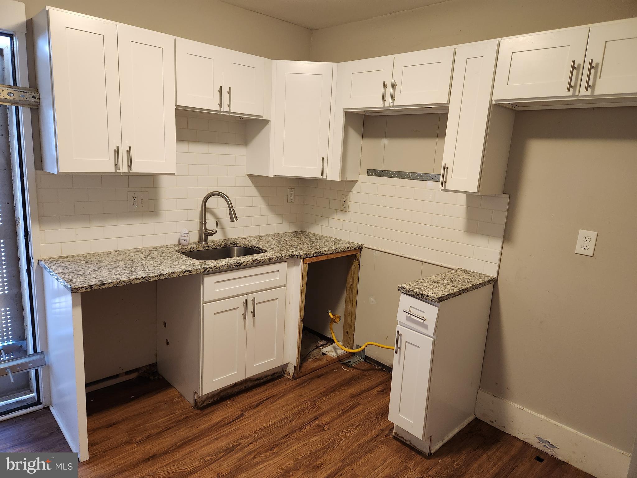 113 Eastern Boulevard Essex, MD 21221 - Photo 8 of 19 a kitchen with a sink cabinets and wooden floor