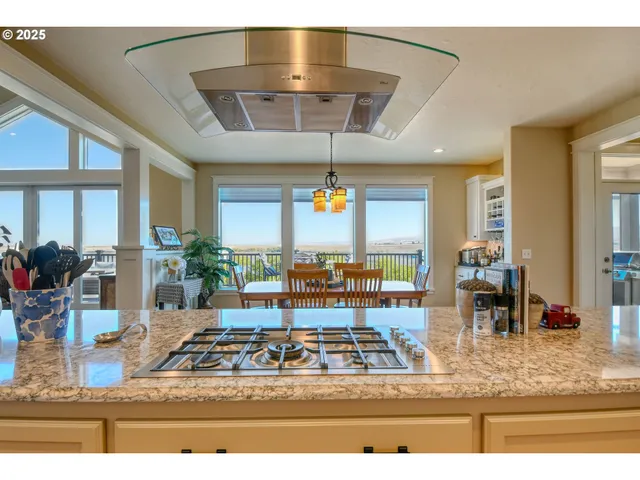 a living room with dining table and a large window