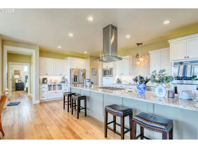 a kitchen with lots of counter top space and painting on the wall