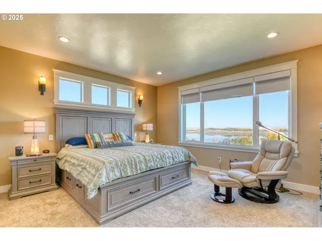 a bedroom with a bed and a large window