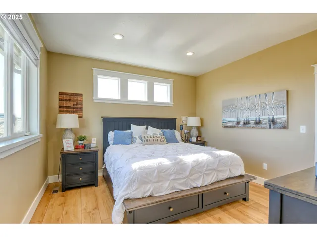 a bedroom with a bed and a painting on the wall