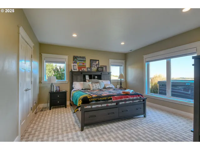 a room with a bed and a large window