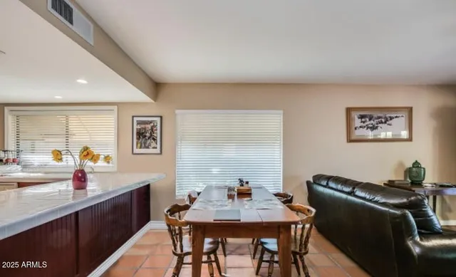 a view of a dining room with furniture and window