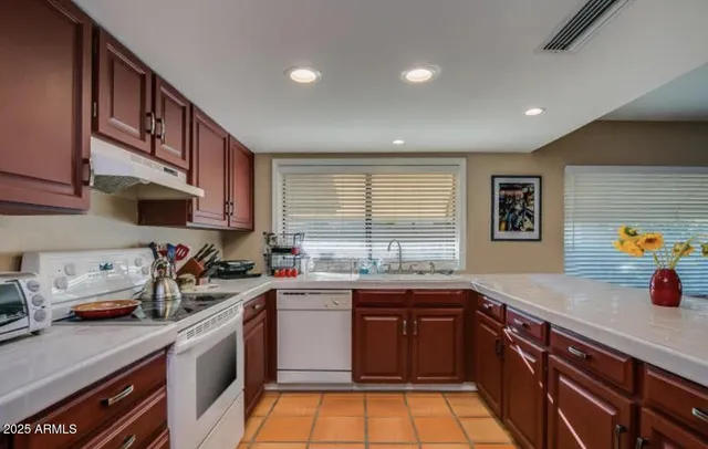 a kitchen with stainless steel appliances a sink stove and cabinets