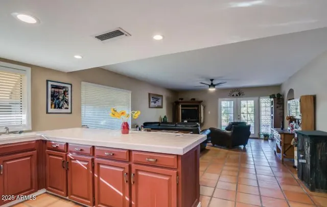 a kitchen with stainless steel appliances granite countertop a sink dishwasher stove top oven and cabinets with wooden floor