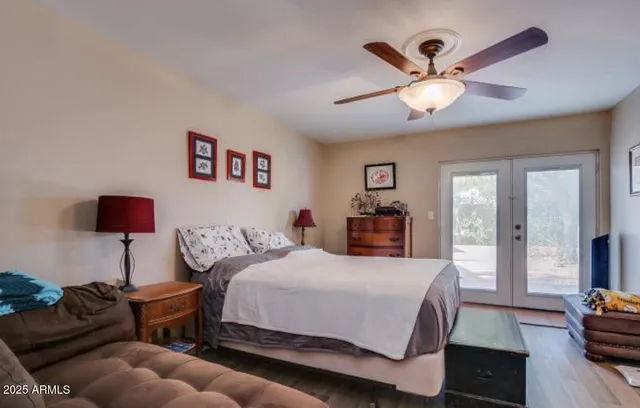 a spacious bedroom with a bed and wooden floor
