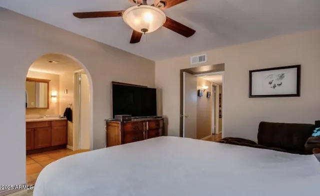 a bedroom with a bed and a flat screen tv