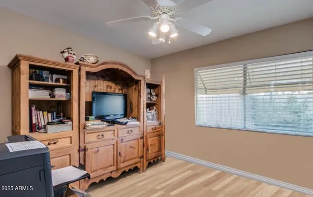 a view of a workspace with furniture and a window