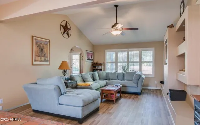 a living room with furniture and a wooden floor
