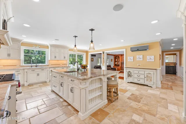 a large white kitchen with a large window