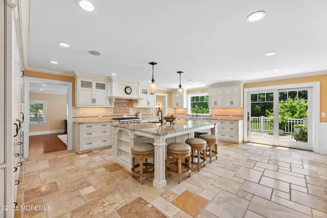 a kitchen with stainless steel appliances granite countertop a sink stove and cabinets