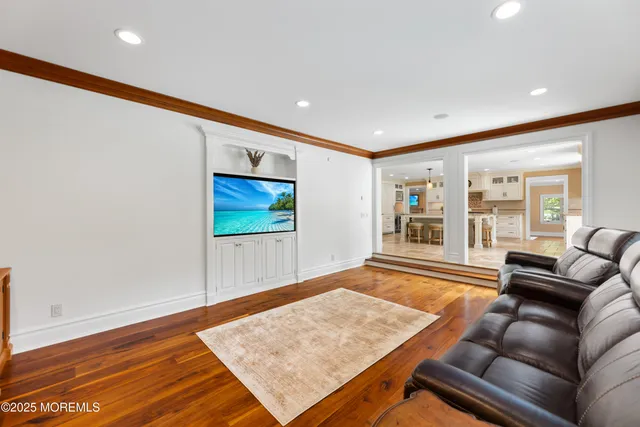 a view of a room with wooden floor and windows