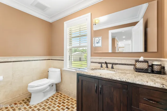 a spacious bathroom with a double vanity sink a large mirror and a bathtub