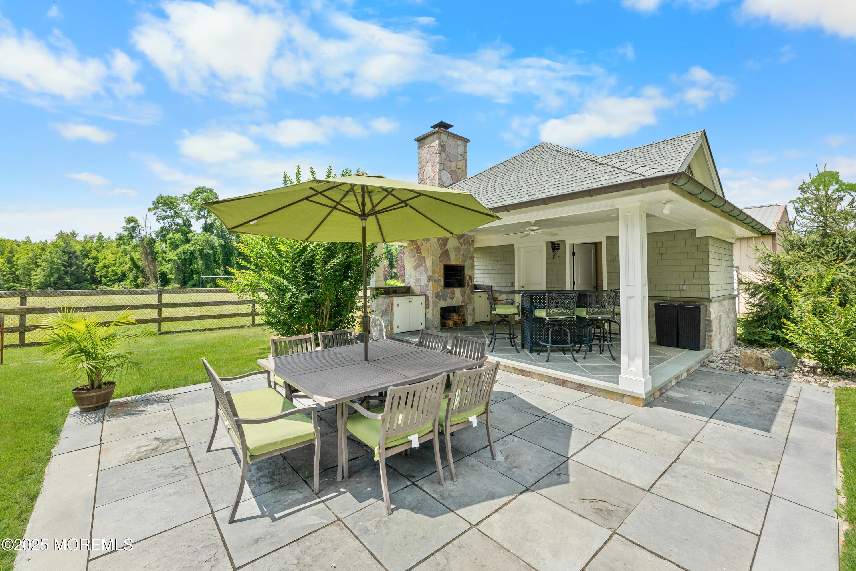 13 Indian Path Millstone Township, NJ 08535 - Photo 30 of 67 a view of a patio with a table and chairs under an umbrella