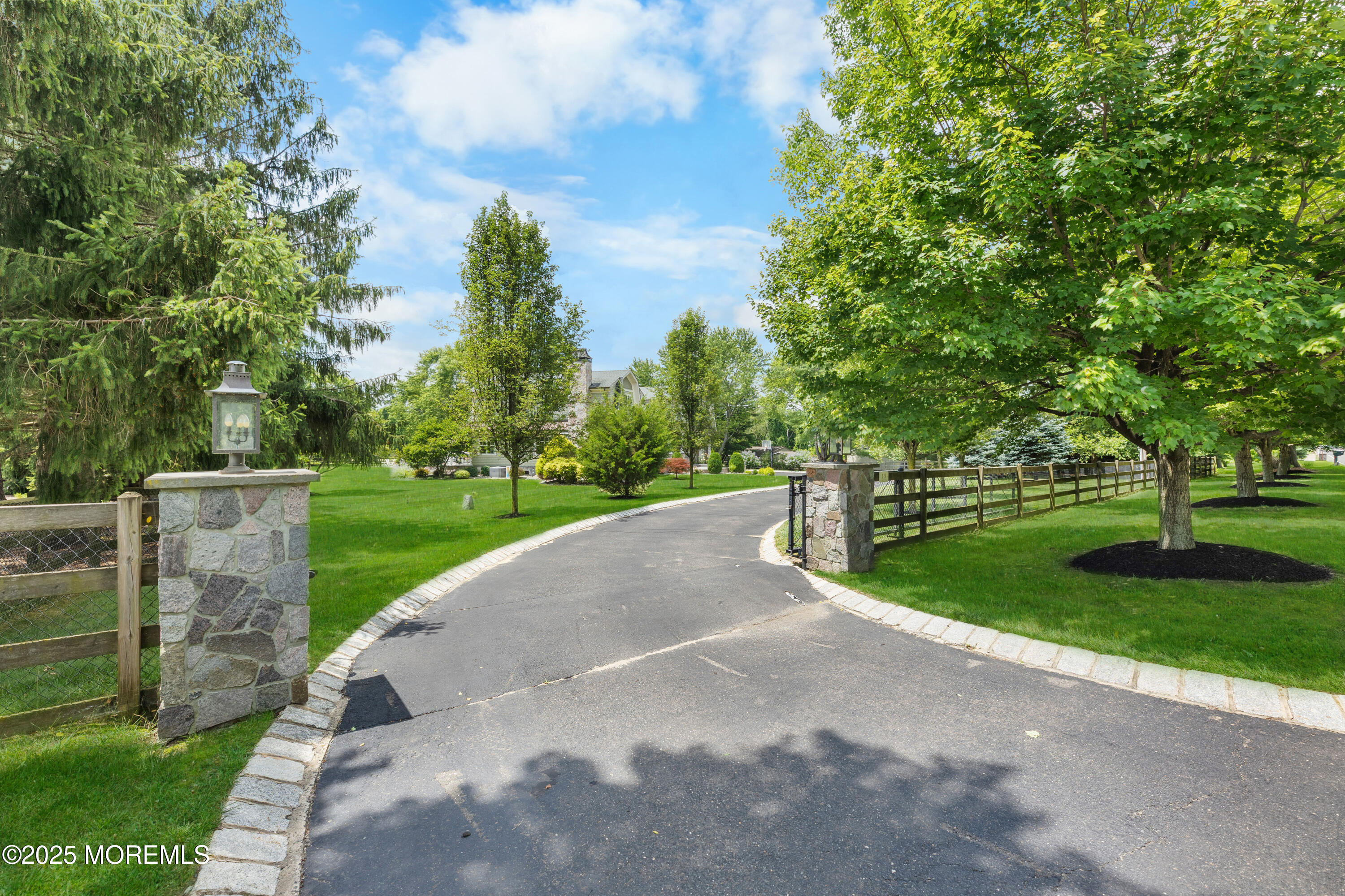 13 Indian Path Millstone Township, NJ 08535 - Photo 3 of 67 a view of a street with a yard and large trees
