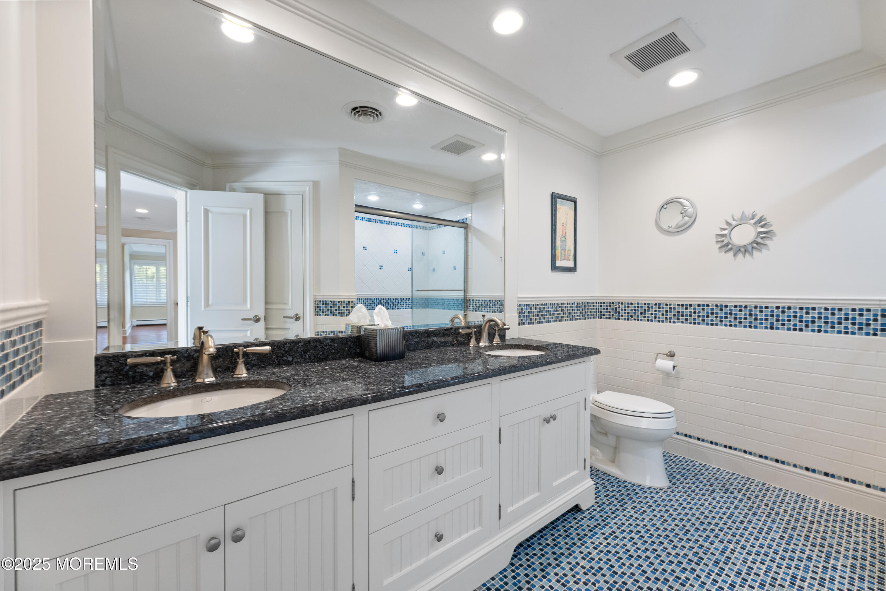 13 Indian Path Millstone Township, NJ 08535 - Photo 41 of 67 a bathroom with a granite countertop toilet a double vanity sink and a mirror