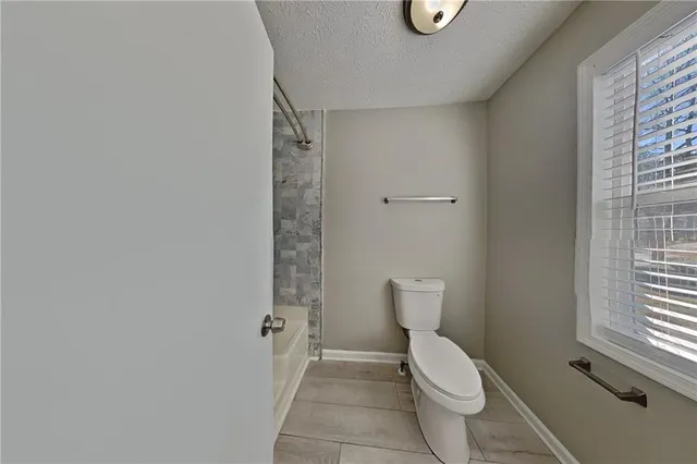 a white toilet sitting next to a window