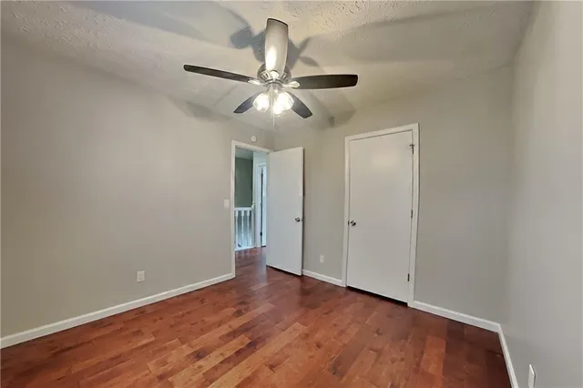 a view of an empty room and wooden floor