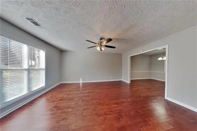 wooden floor in an empty room with a window
