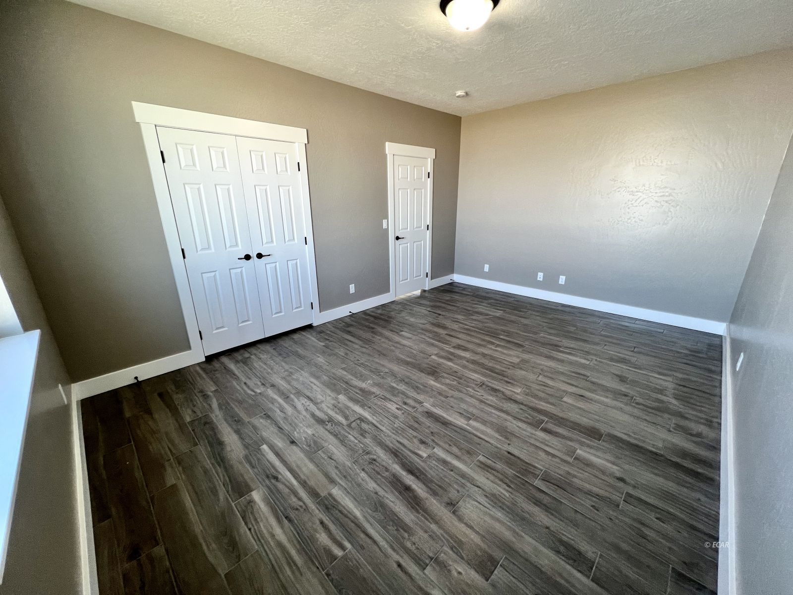 298 Ridgeway Drive Spring Creek, NV 89815 - Photo 17 of 45 a view of an empty room with wooden floor