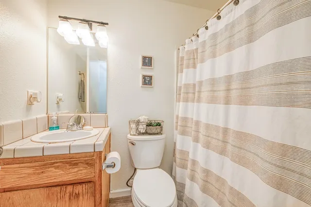 a bathroom with a toilet a sink and a mirror