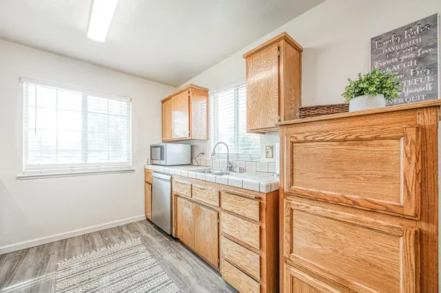 a kitchen with stainless steel appliances granite countertop cabinets and window