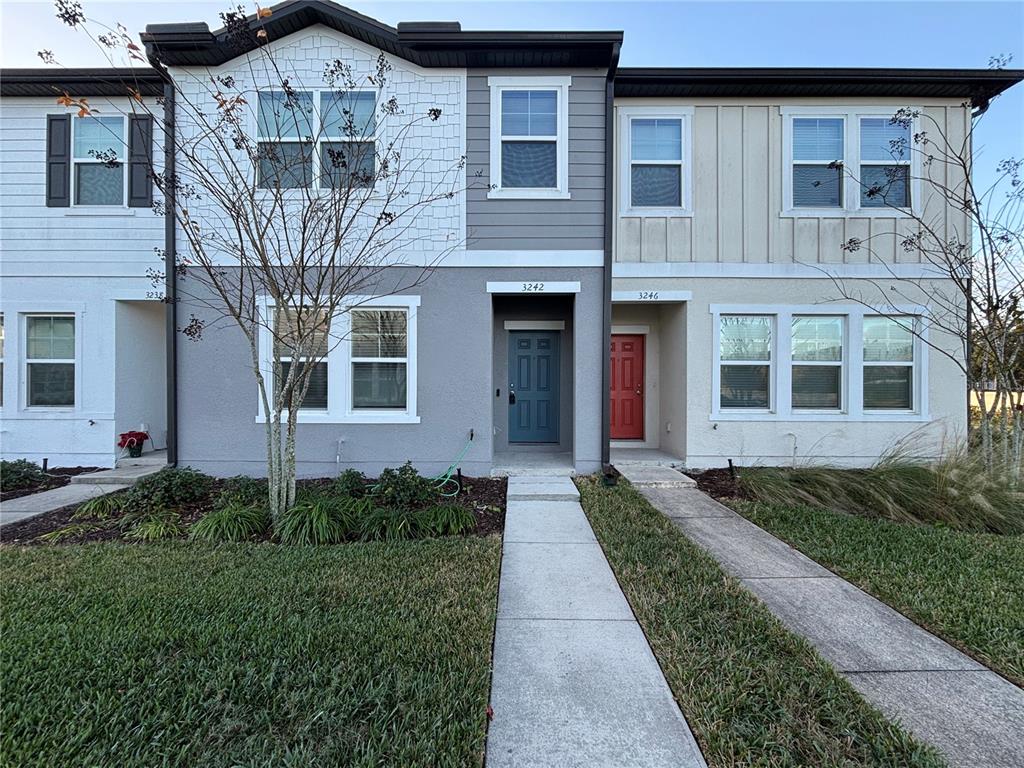 3242 Azolla Street Orlando, FL 32808 - Photo 1 of 1 a front view of a house with a garden